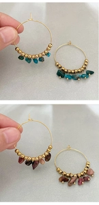 Detail view of bohemian hoop earrings with natural crushed stones and golden metal beads
