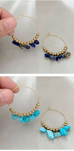 Detail of bohemian gold hoop earrings with irregular natural blue lapis and turquoise stones