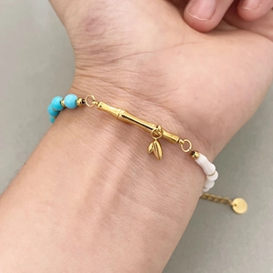 Vintage asymmetric bracelet with turquoise beads and gold bamboo metal elements