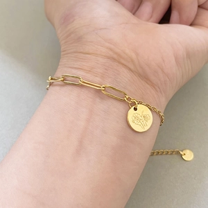Gold double-layered paperclip chain bracelet with a floral engraved round charm