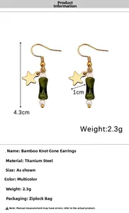 Macro detail of star and bamboo-shaped bead earrings with measurements 4.3cm length
