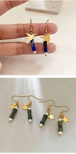 Detailed shot of retro gold earrings with bamboo-shaped beads and elegant pearls