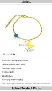 Detailed view of gold stainless steel bracelet with blue heart stone and butterfly charm