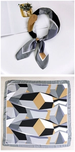 Detail of 70cm silk square scarf featuring modern grey and yellow geometric cube patterns