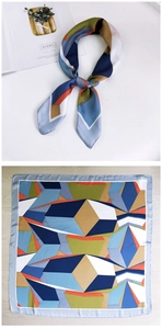 Detail of silk-feel square scarf featuring 3D geometric patterns and light blue hem stitching