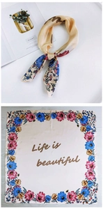 Detail of a square silk scarf with floral borders and Life is beautiful text print