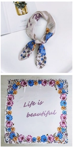 Flat lay of floral silk square scarf with Life is beautiful text and elegant flower border