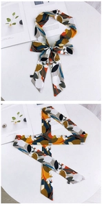 Détail d'un foulard en soie aux motifs floraux artistiques et à la texture satinée lisse