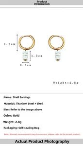 Detail view of gold hoop earrings with natural shell pendants including size and weight info