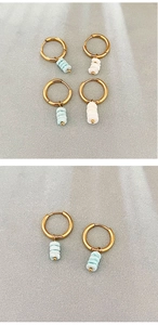 Detailed view of handmade geometric drop earrings with blue natural stone beads