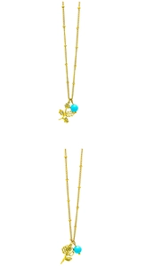 Detail of gold floral necklaces featuring turquoise beads and rose pendants