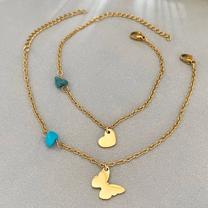 Golden butterfly and heart charm bracelets with blue gemstone pendants and thin chains