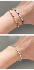 Detail shot of multi-colored 3mm crystal beads on a thin 18k gold plated bracelet