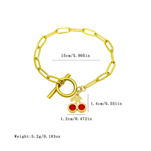 Bracelet trombone en acier doré avec pendentif cerise en cristal et fermoir à bascule OT