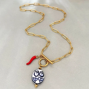 Gold paperclip chain necklace with red chili and blue flower ceramic pendants
