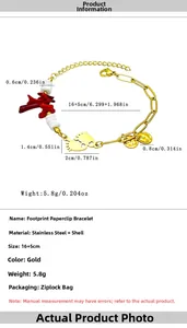 Detail view of gold stainless steel bracelet with red coral and shell bead charms