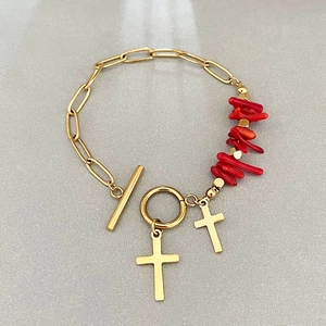 Golden paperclip chain bracelet with red branch beads and dual cross charms featuring toggle clasp