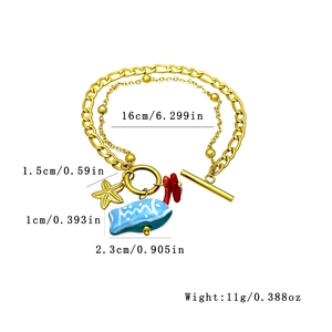 Bracelet double couche en acier doré avec breloques étoile de mer et poisson bleu