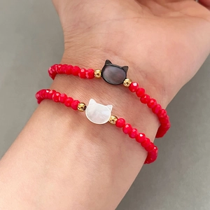 Red beaded stretch bracelets with cat charms in black and white finish for women