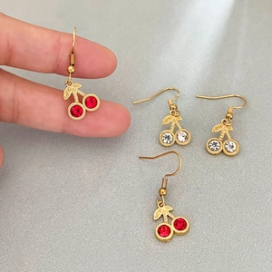 Elegant stainless steel cherry earrings with red and white crystals and gold leaf detail