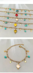 Detail of beach-style bracelets with colorful shells, turquoise stones and gold stars