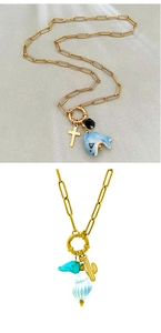 Detail of 18K gold-plated necklace with dolphin, shell and cactus ceramic pendants