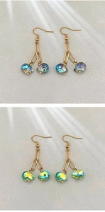 Detail of colorful faceted crystal teardrop earrings with elegant gold-plated hooks