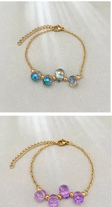Detail of multi-faceted crystal bead bracelets with gold chain and lobster clasp