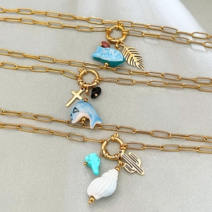Three 18K gold plated stainless steel necklaces featuring whale dolphin and shell pendants