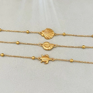 Gold stainless steel ocean-themed bracelet set featuring shell, conch, and turtle charms