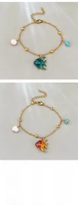 Detail of 18K gold-plated fish charm bracelets with freshwater pearls and colorful enamel