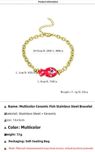 Detail view of 18k gold plated stainless steel bracelet with red ceramic fish pendant