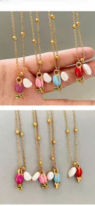 Detail of tulip pendant necklace set with enamel flower and baroque pearl in four colors