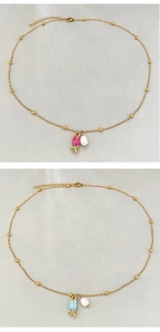 Detail of vintage gold tulip necklaces with pink and blue enamel and pearl accents
