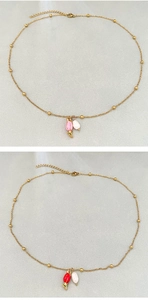 Detailed view of vintage gold tulip pendant necklaces with red and pink enamel and pearls