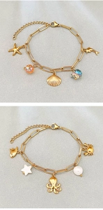 Detail of gold stainless steel ocean bracelets featuring starfish and octopus charms