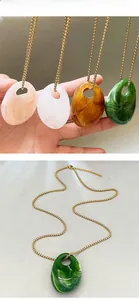 Macro shot of irregular resin geometric pendants on gold metal chains in four colors