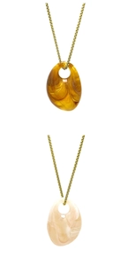 Detail of irregular geometric acrylic marble pendants in amber brown and cream white colors
