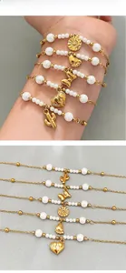 Detail of 5-piece gold bead bracelet set with cactus heart butterfly and star pendants