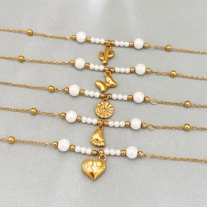 Five-piece gold beaded bracelet set with heart, butterfly, and moon star pendants