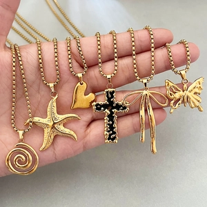 Golden vintage necklace set with heart, cross, and butterfly pendants on box chains