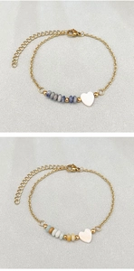 Detail of gold chain bracelets featuring colorful natural stone beads and heart charms