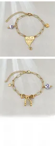 Detail view of 18k gold plated bracelets with heart, bow, and blue ceramic beads