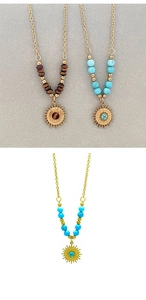 Detail of 18k gold plated sun pendant necklace with turquoise and tiger eye stone beads