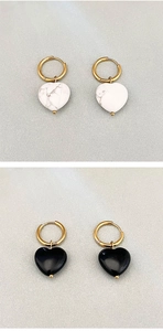 Dettaglio di orecchini placcati oro 18K con ciondoli a cuore in marmo e nero