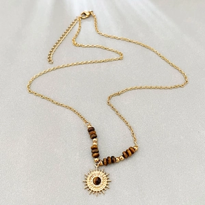 Golden stainless steel necklace with tiger eye stone and sunburst pendant in boho style