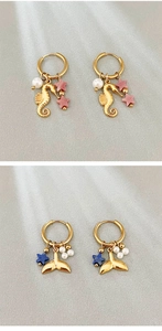 Detail of gold seahorse and whale tail earrings with pearls and colorful stars