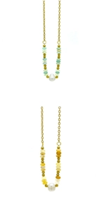 Detail of 18k gold plated necklaces with natural stones and large white freshwater pearl