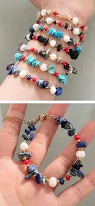 Detail of freshwater pearl and natural gemstone beaded bracelet with gold lobster clasp