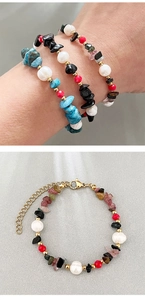Detail of layered boho bracelet with freshwater pearls, black gravel, and turquoise beads
